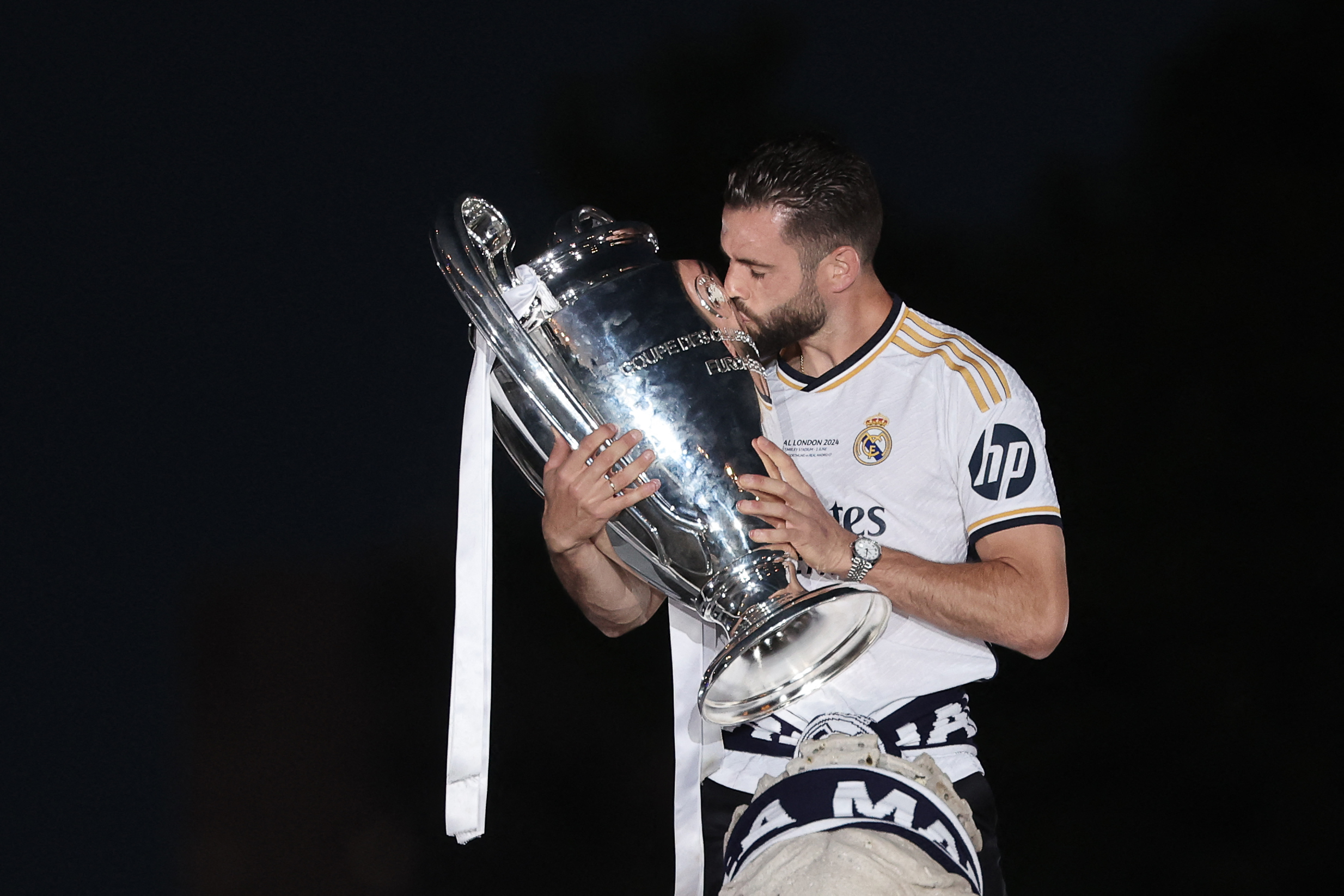 Real Madrid's Spanish defender #06 Nacho Fernandez celebrates with the trophy their 15th Champions League win, one day after beating Borussia Dortmund in London, on Cibeles square in Madrid on June 2, 2024.